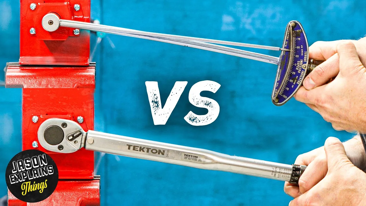 A vintage beam torque wrench laid beside two modern click-type wrenches before an accuracy test