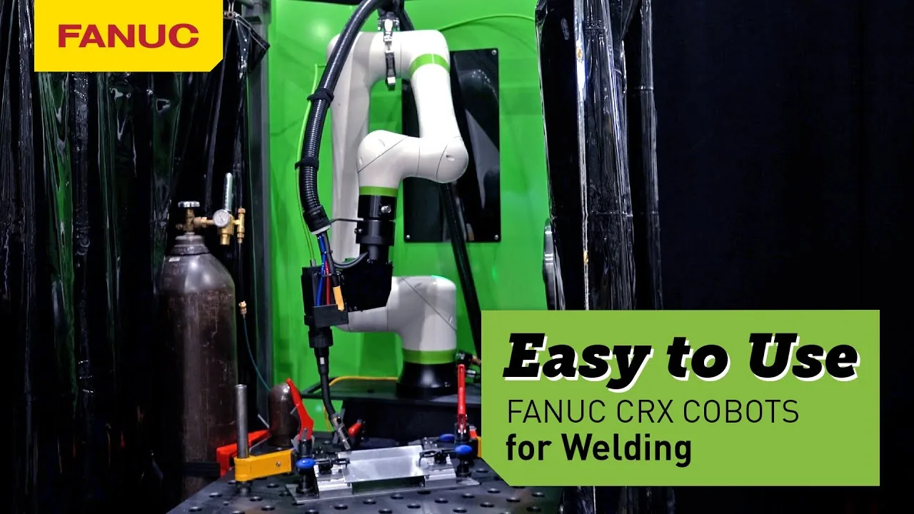 A FANUC CRX cobot with a welding torch over a clamped steel part on a slotted fixture table, gas cylinder and welding curtains behind
